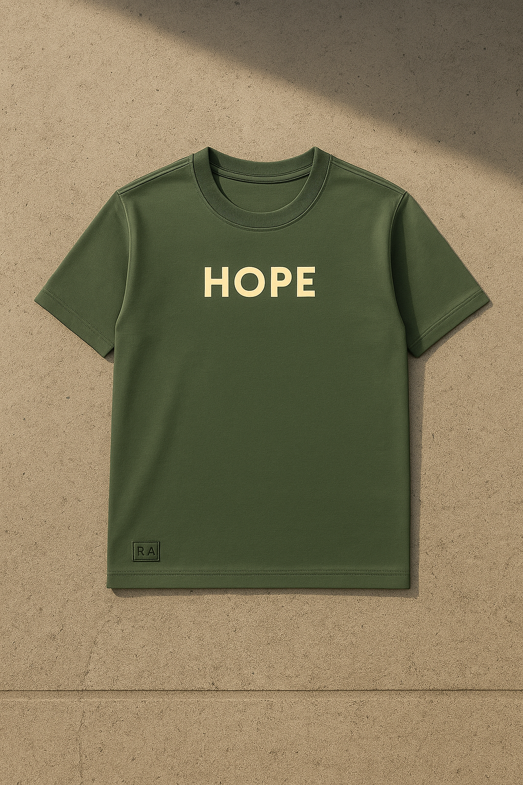 Green t-shirt with 'HOPE' printed on it against a beige background