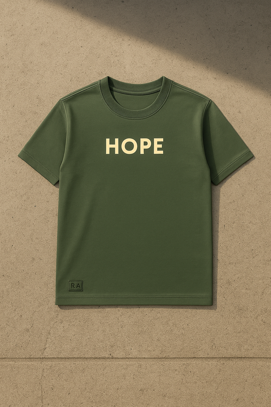 Green t-shirt with 'HOPE' printed on it against a beige background