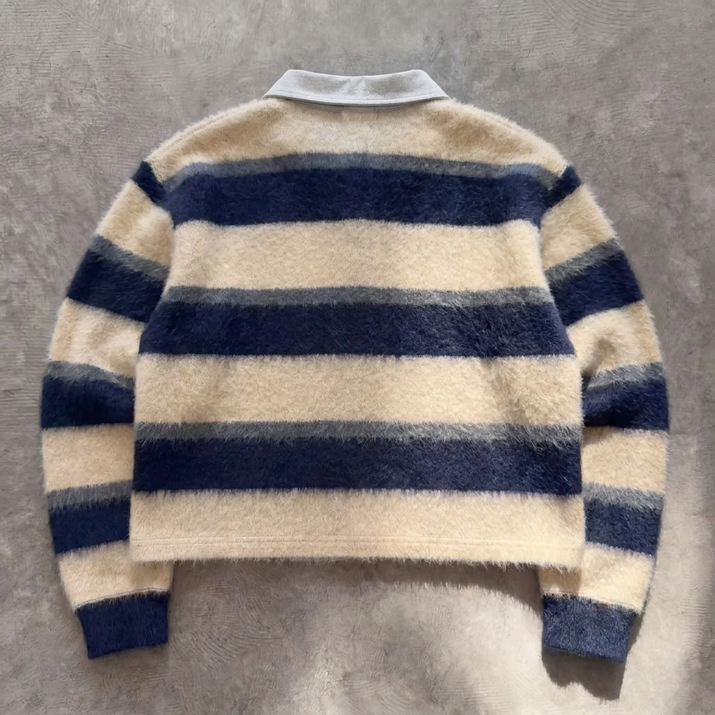 Striped sweater with blue and beige colors on a gray background