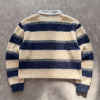 Striped sweater with blue and beige colors on a gray background