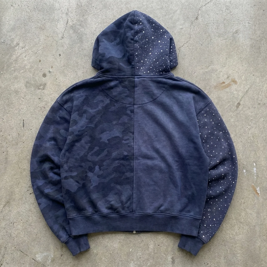 Blue camouflage hoodie on a concrete surface