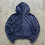 Blue camouflage hoodie on a concrete surface