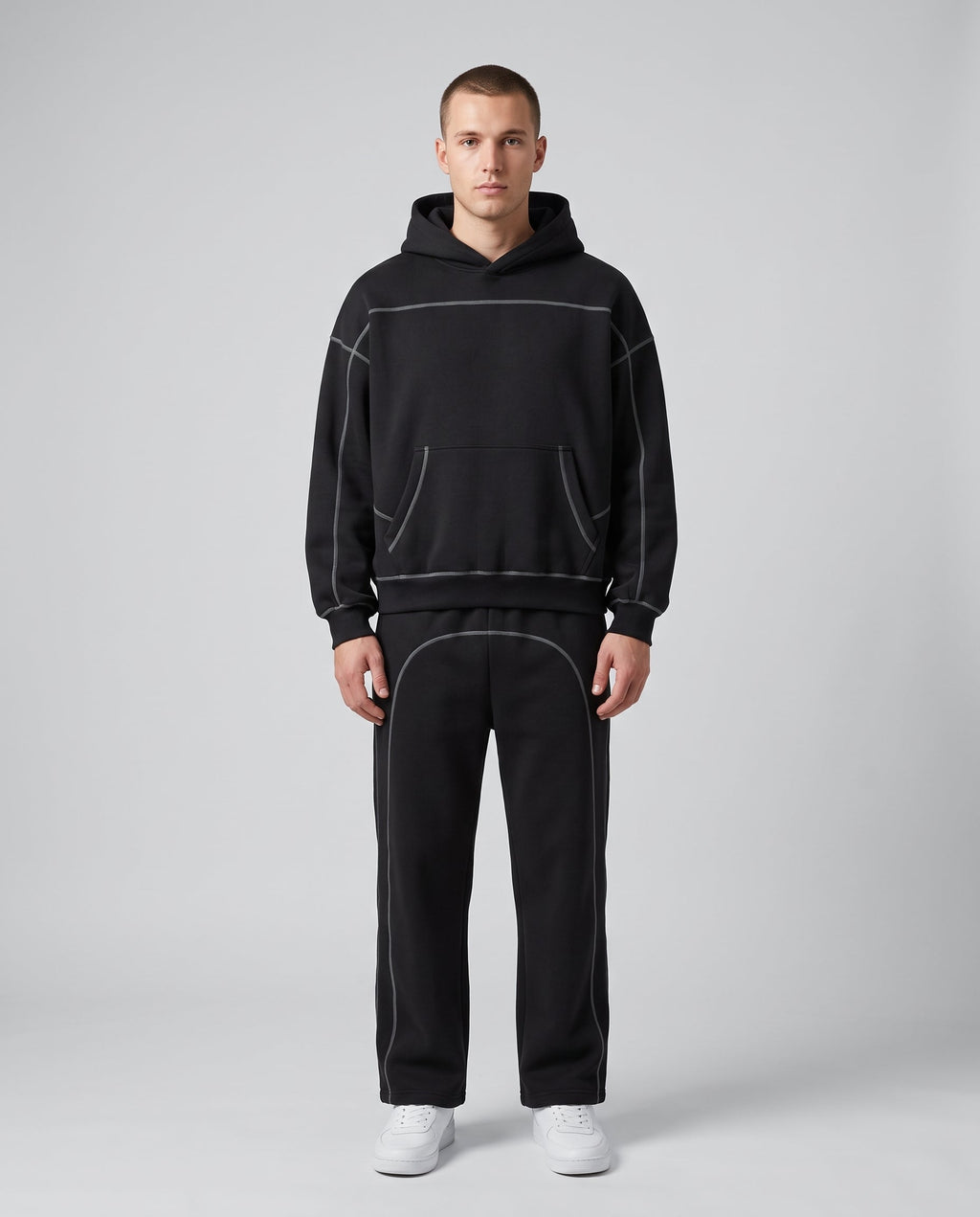 Contrast-stitched hoodie and sweatpants set in black, worn together