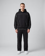 Contrast-stitched hoodie and sweatpants set in black, worn together