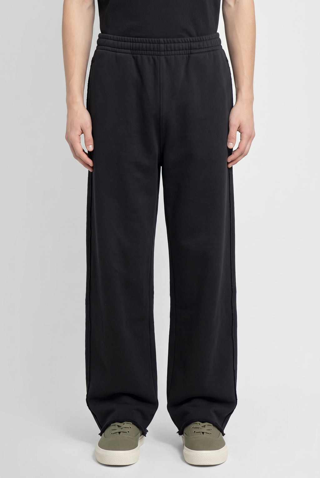 Righteous Snow Washed Raw Edge Sweatpants in black, worn, front view of the legs