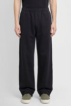 Righteous Snow Washed Raw Edge Sweatpants in black, worn, front view of the legs