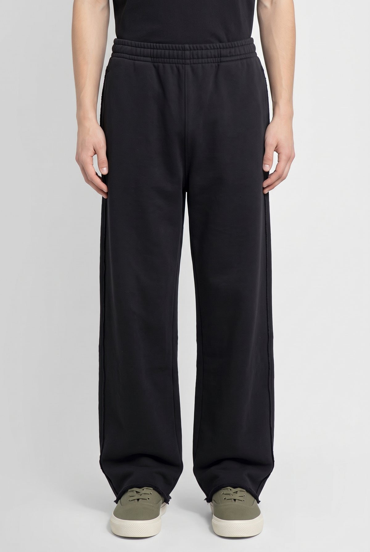 Righteous Snow Washed Raw Edge Sweatpants in black, worn, front view of the legs