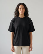 Righteous Oversized Contrast-Stitched Cotton Tee in black, front on a model
