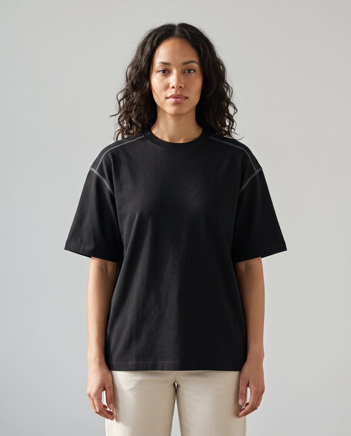 Righteous Oversized Contrast-Stitched Cotton Tee in black, front on a model