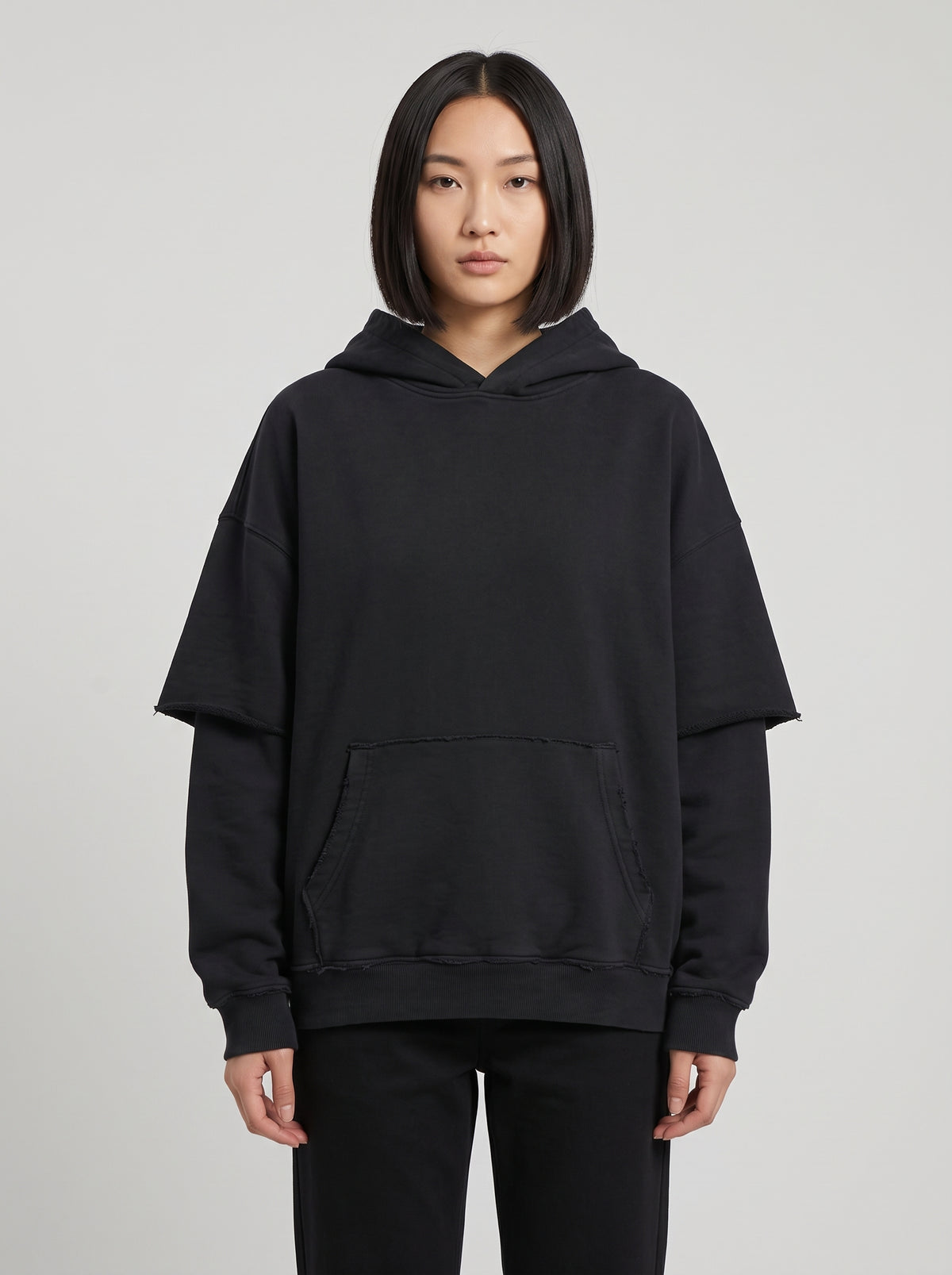 Righteous Snow Washed Raw Edge Double Layered Hoodie in black, front on a model