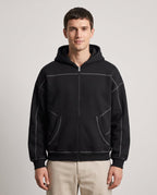Righteous Contrast-Stitched Boxy Fleece Zip Hoodie in black, front on a model