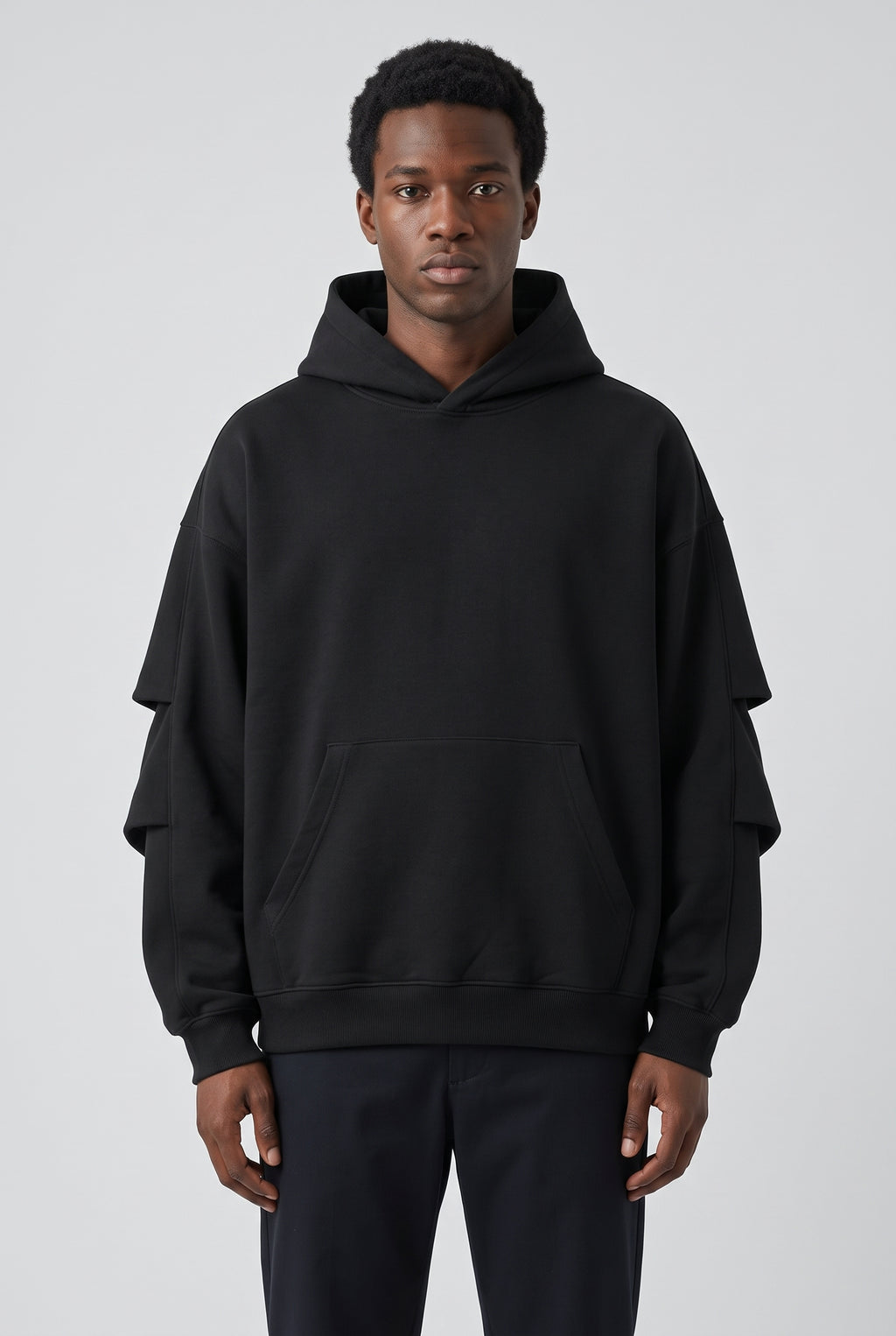 Righteous Unisex Heavyweight Ruched Sleeves Hoodie in black, front on a model