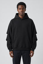 Righteous Unisex Heavyweight Ruched Sleeves Hoodie in black, front on a model
