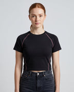 Righteous Women's Contrast Stitch Raglan Crop T-Shirt in black, front on a model